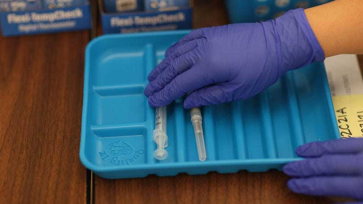 A healthcare worker prepares Moderna COVID-19 vaccines at a clinic set up by Healthcare Network on May 20, 2021 in Immokalee, Florida.