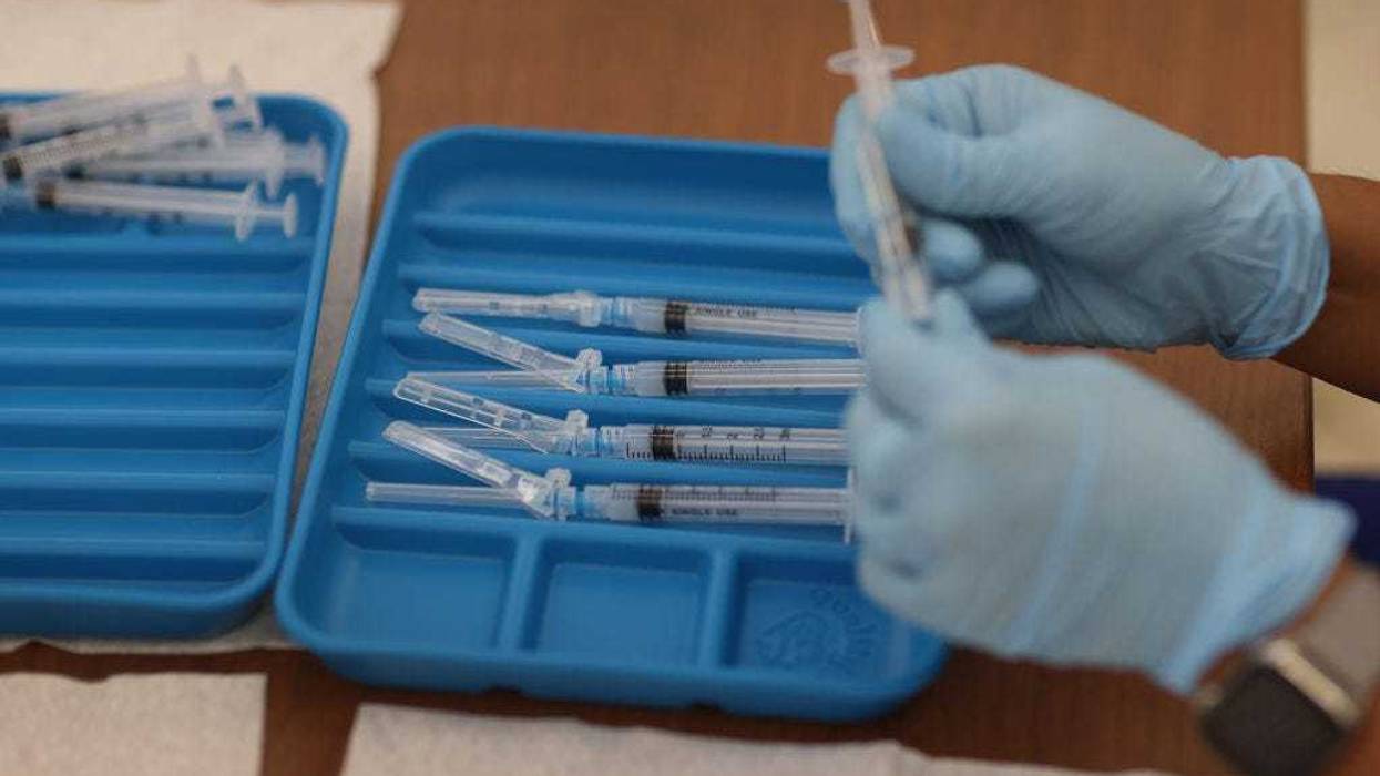 A healthcare worker prepares Moderna COVID-19 vaccines at a clinic set up by Healthcare Network on May 20, 2021 in Immokalee, Florida.