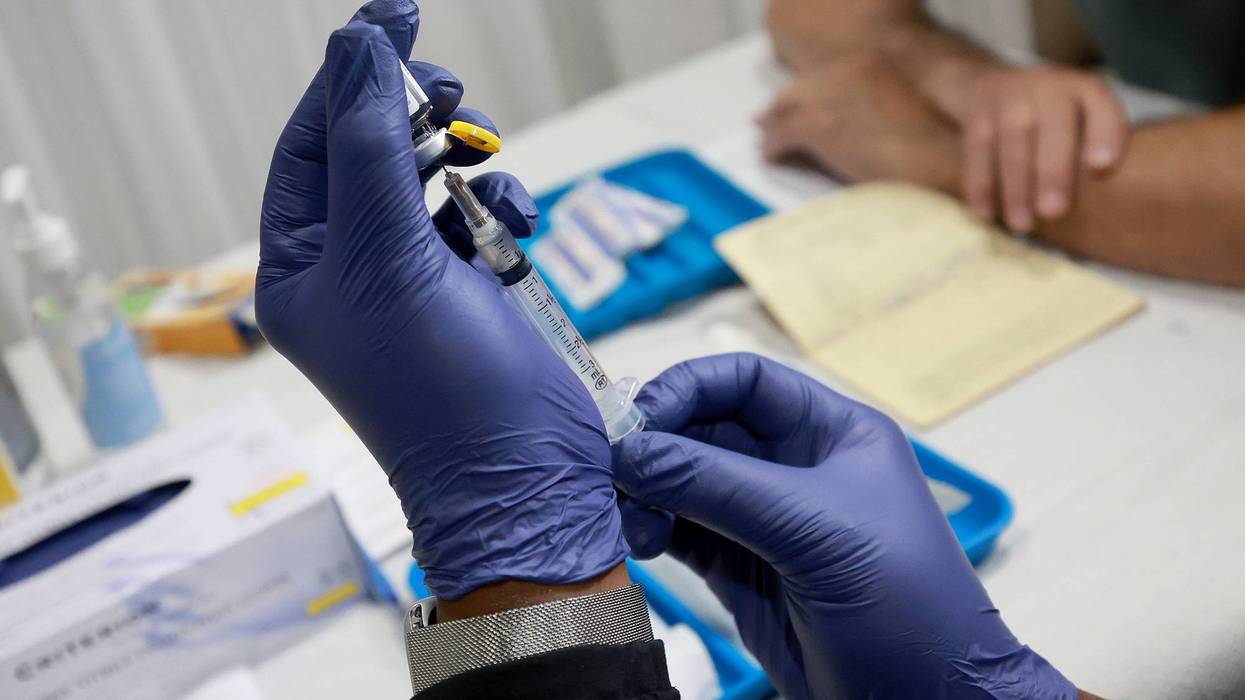 A healthcare worker prepares to administer a vaccine to a person for the prevention of monkeypox the Pride Center on July 12, 2022 in Wilton Manors, Florida.