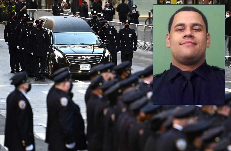 A hearse carrying the casket of NYPD Officer Wilbert Mora arrives at St. Patrick