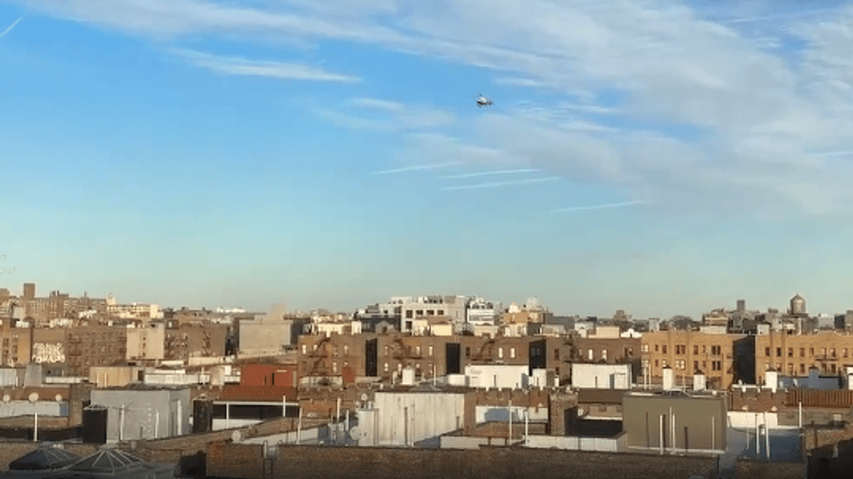 A helicopter in the distances searches for suspects for the stabbing of a teen in Sunnyside, Queens, on Feb. 14, 2025.