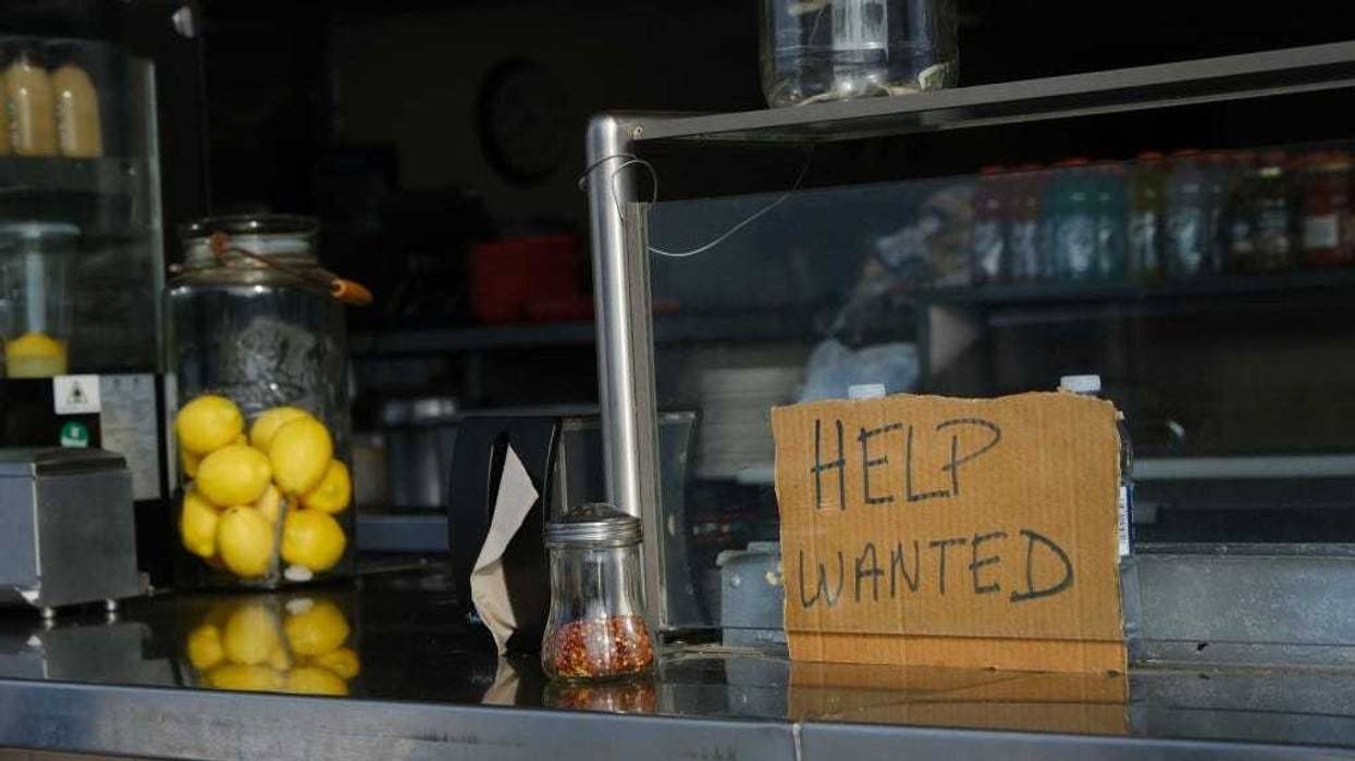 A help wanted sign is displayed at a boardwalk restaurant the day before the Memorial Day weekend, the unofficial start of summer, in the shore community of Wildwood on May 28, 2021 in Wildwood, New Jersey.
