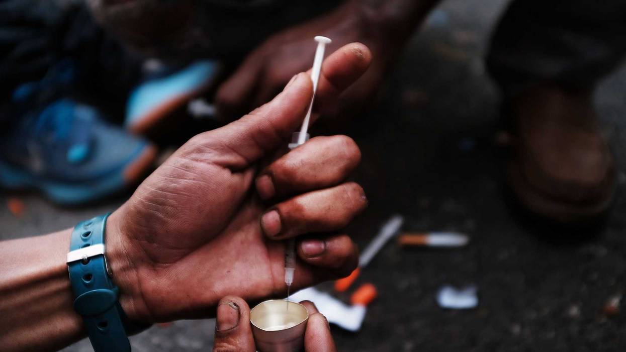 A heroin user prepares to shoot up on the street in a South Bronx neighborhood which has the highest rate of heroin-involved overdose deaths in the city on October 7, 2017 in New York City.