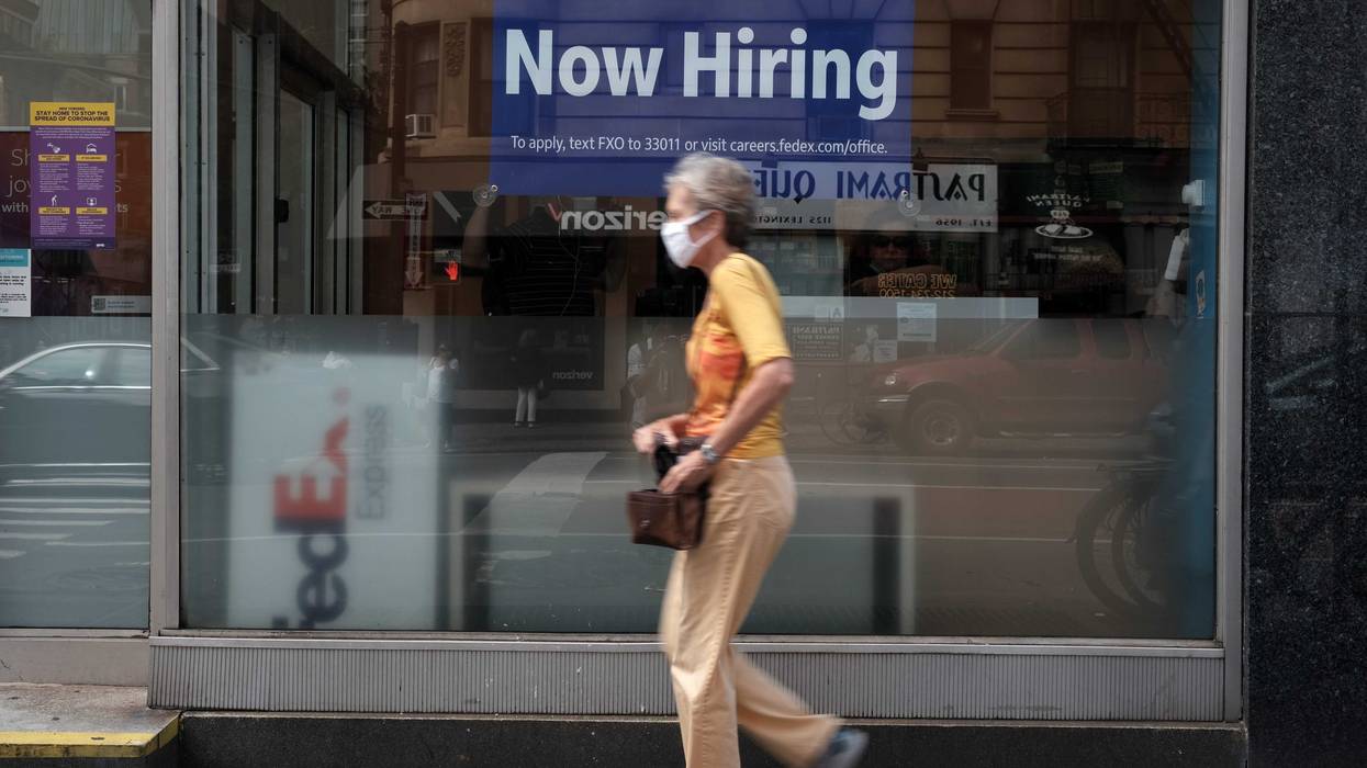 A hiring sign is displayed in a store window in Manhattan.