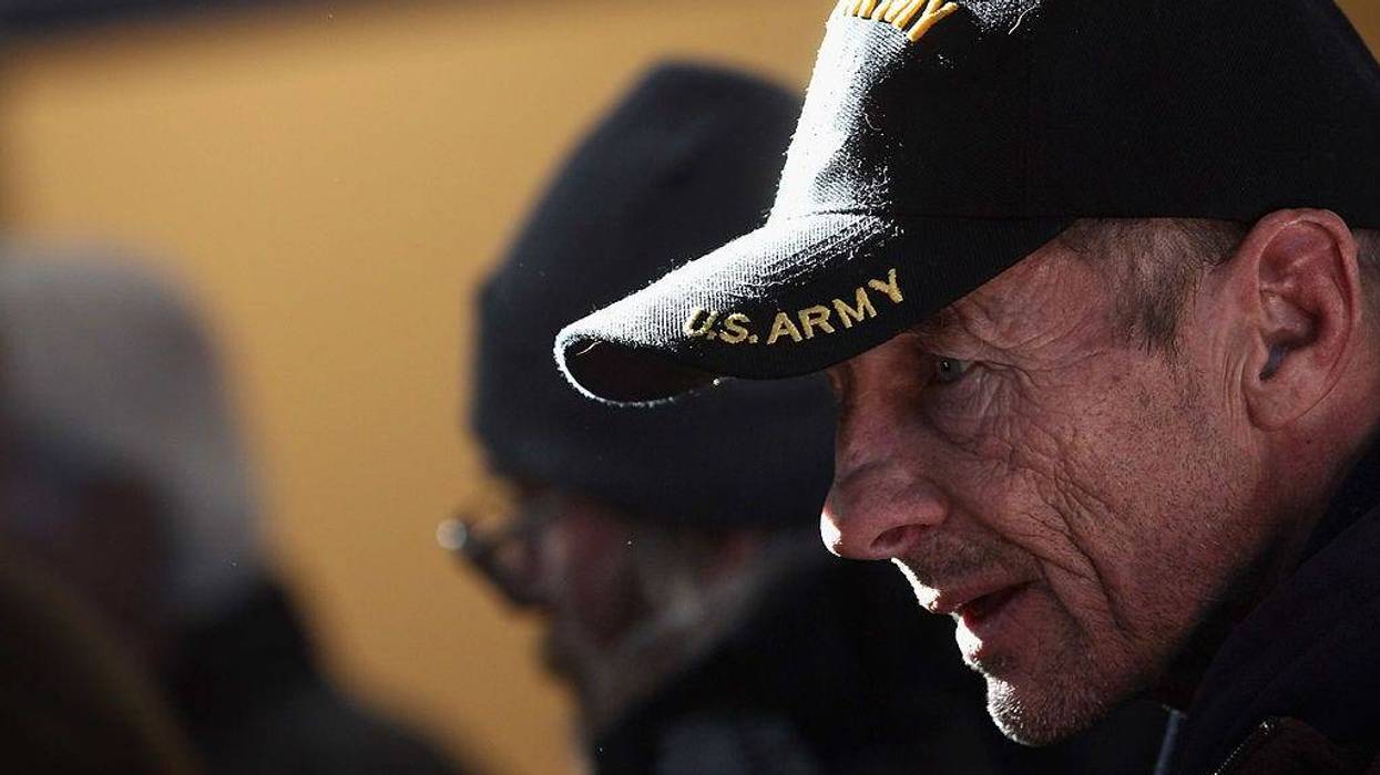 A homeless U.S. military veteran stands in line for free winter clothing.