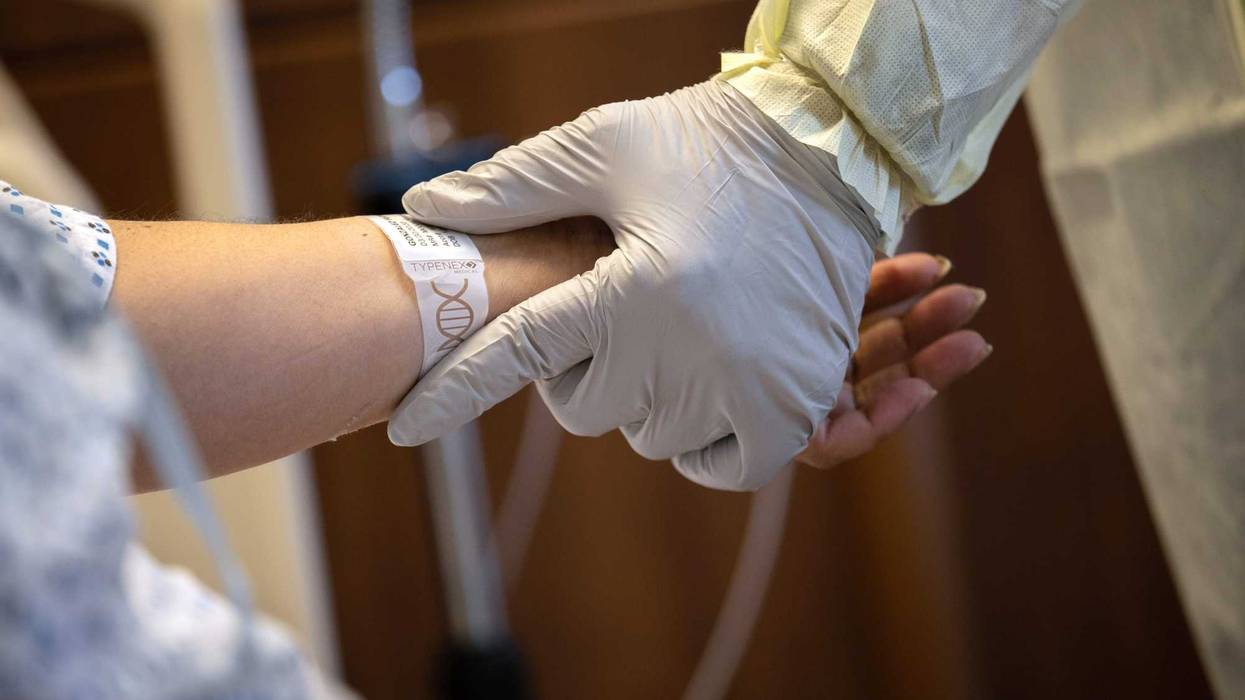 A hospital worker prepares COVID-19 patient and Guatemalan asylum seeker Zully to take her first steps after being removed from a ventilator at a Stamford Hospital ICU on April 24, 2020 in Stamford, Connecticut.