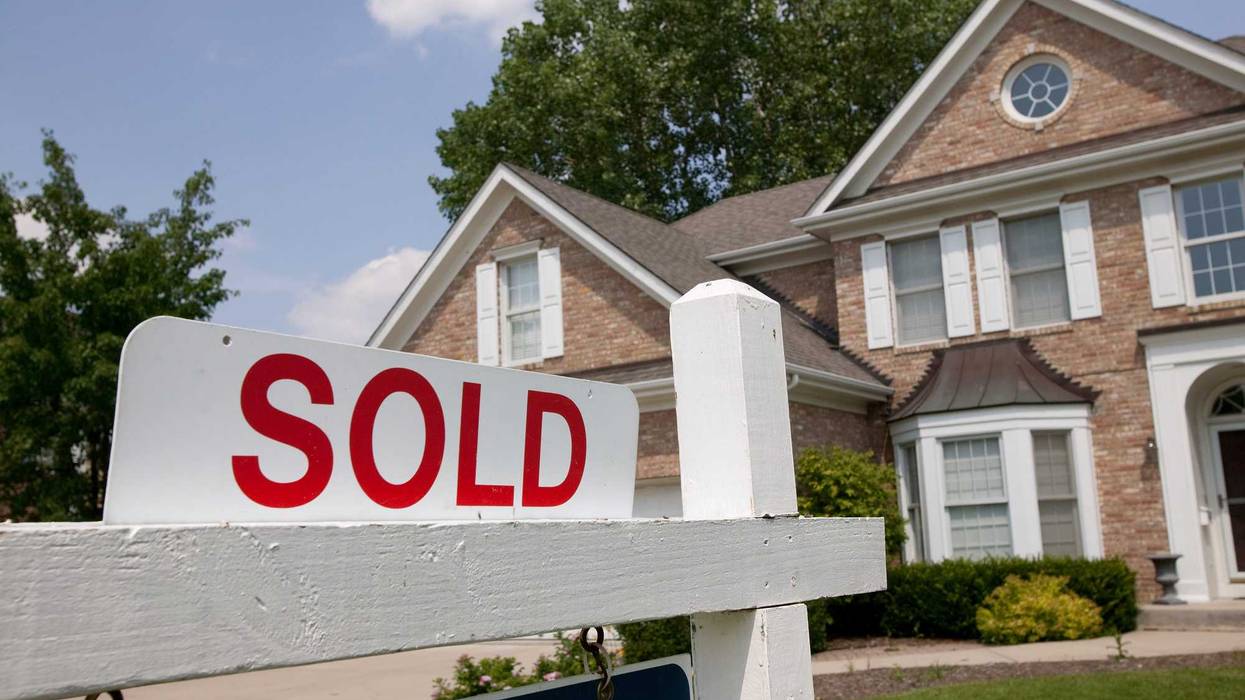 A house with a sold sign in front.