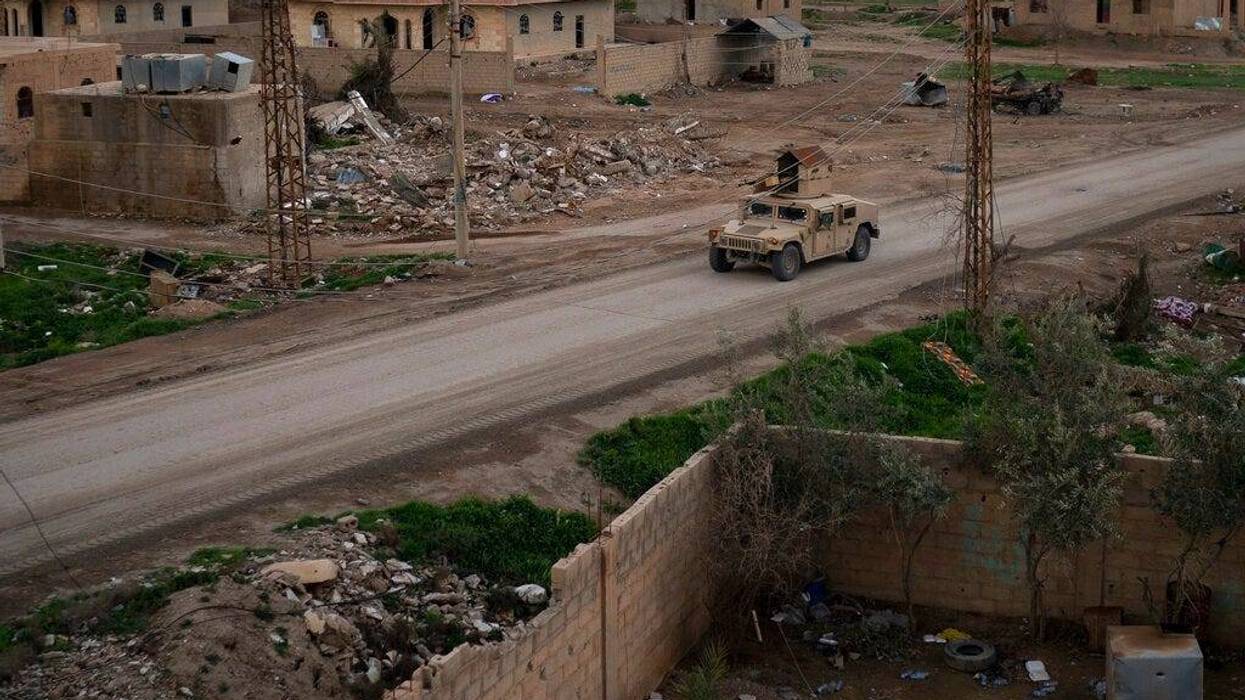A Humvee drives in a village recently retaken from Islamic State militants by U.S.-backed Syrian Democratic Forces (SDF) near Baghouz, Syria, Sunday, Feb. 17, 2019