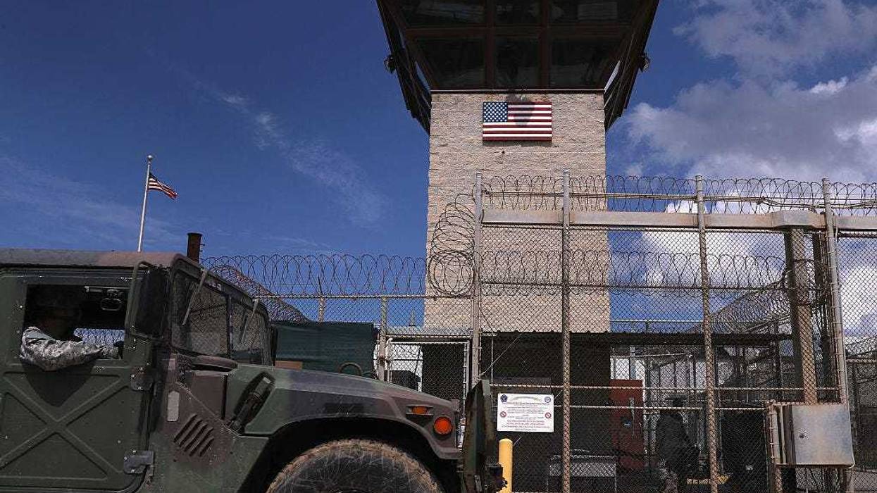 A humvee passes the guard tower guard tower at the entrance of the U.S. prison at Guantanamo Bay, also known as "Gitmo" on October 23, 2016 at the U.S. Naval Station at Guantanamo Bay, Cuba.