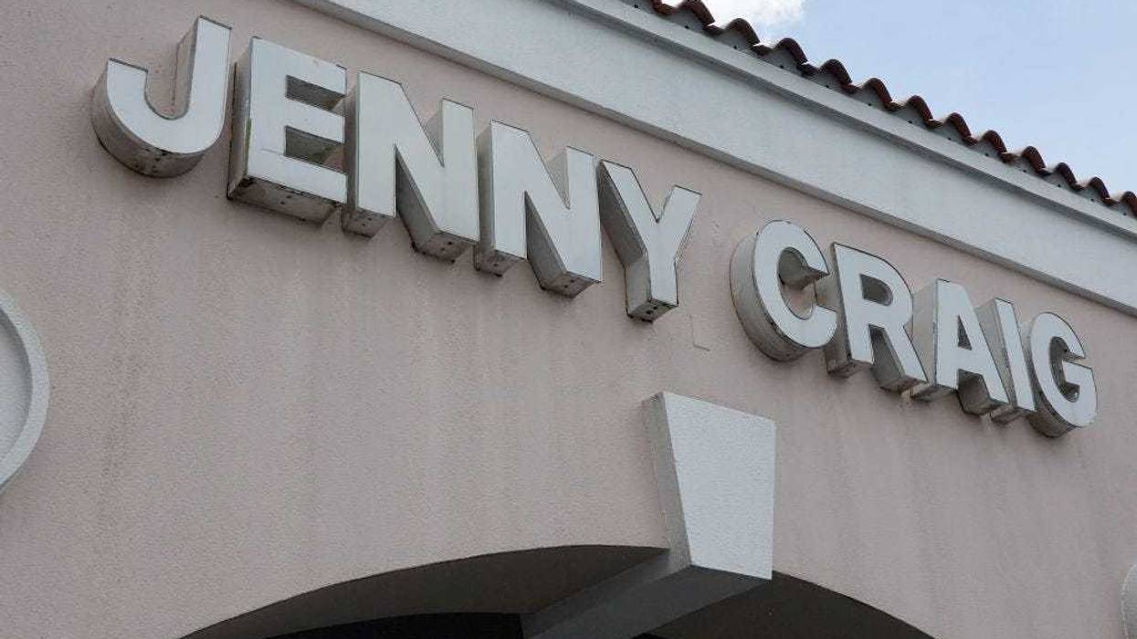 A Jenny Craig sign hangs on the wall outside of the weight loss store on April 28, 2023 in Miami, Florida. (Photo by Joe Raedle/Getty Images)