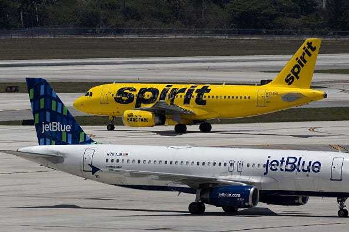 A JetBlue Airlines plane near a Spirit Airlines plane at the Fort Lauderdale-Hollywood International Airport on May 16, 2022 in Fort Lauderdale, Florida. JetBlue announced it is taking a hostile position in its effort to acquire Spirit Airlines. Spirit previously rejected a takeover offer from JetBlue, favoring an earlier deal to merge with Frontier airlines.