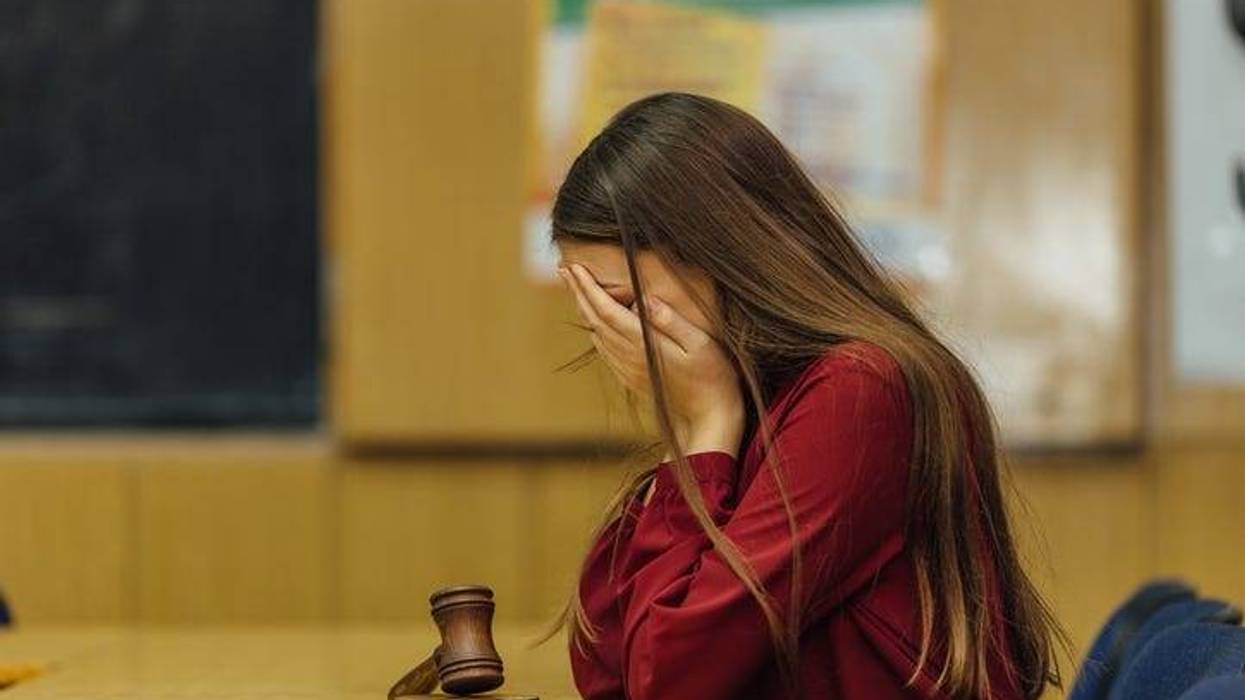 A judge in a courtroom striking the gavel
