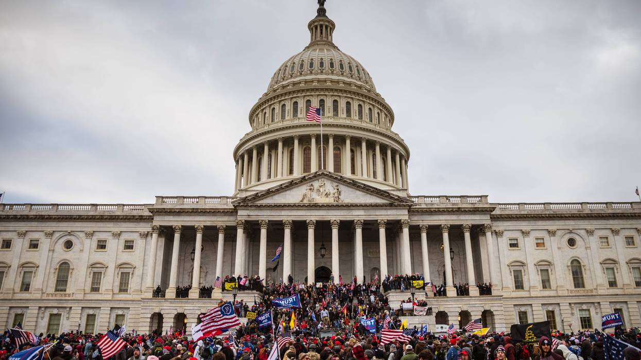 A large group of pro-Trump protesters stand on the East steps of the Capitol Building after storming its grounds on January 6, 2021 in Washington, DC. A pro-Trump mob stormed the Capitol, breaking windows and clashing with police officers. Trump supporters gathered in the nation's capital today to protest the ratification of President-elect Joe Biden's Electoral College victory over President Trump in the 2020 election.
