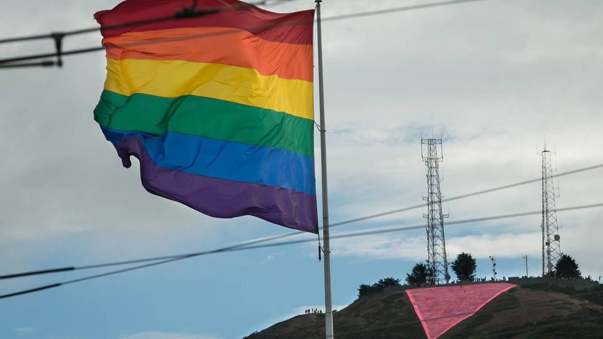 A large pink triangle is seen behind a rainbow flag during a gay pride celebration on June 27, 2015 in San Francisco, California.