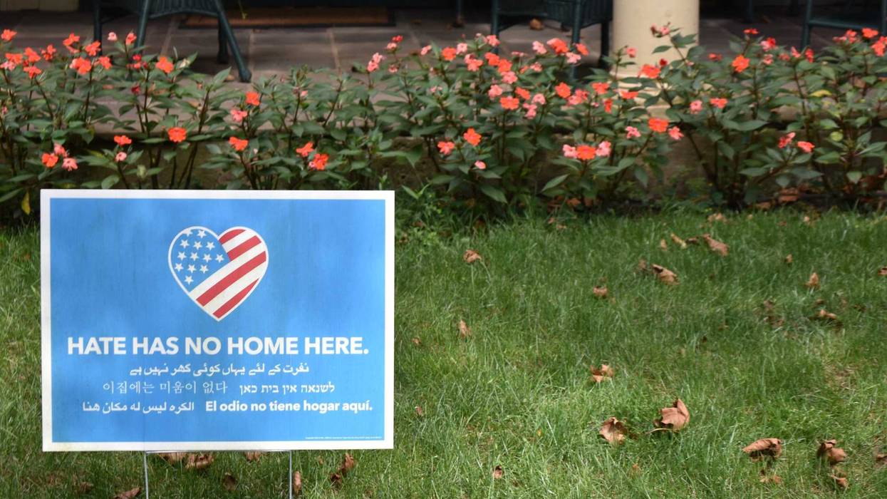 A lawn sign reads "Hate Has No Home Here"