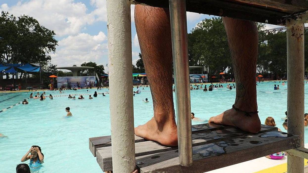 A lifeguard watches as people enjoy a hot afternoon