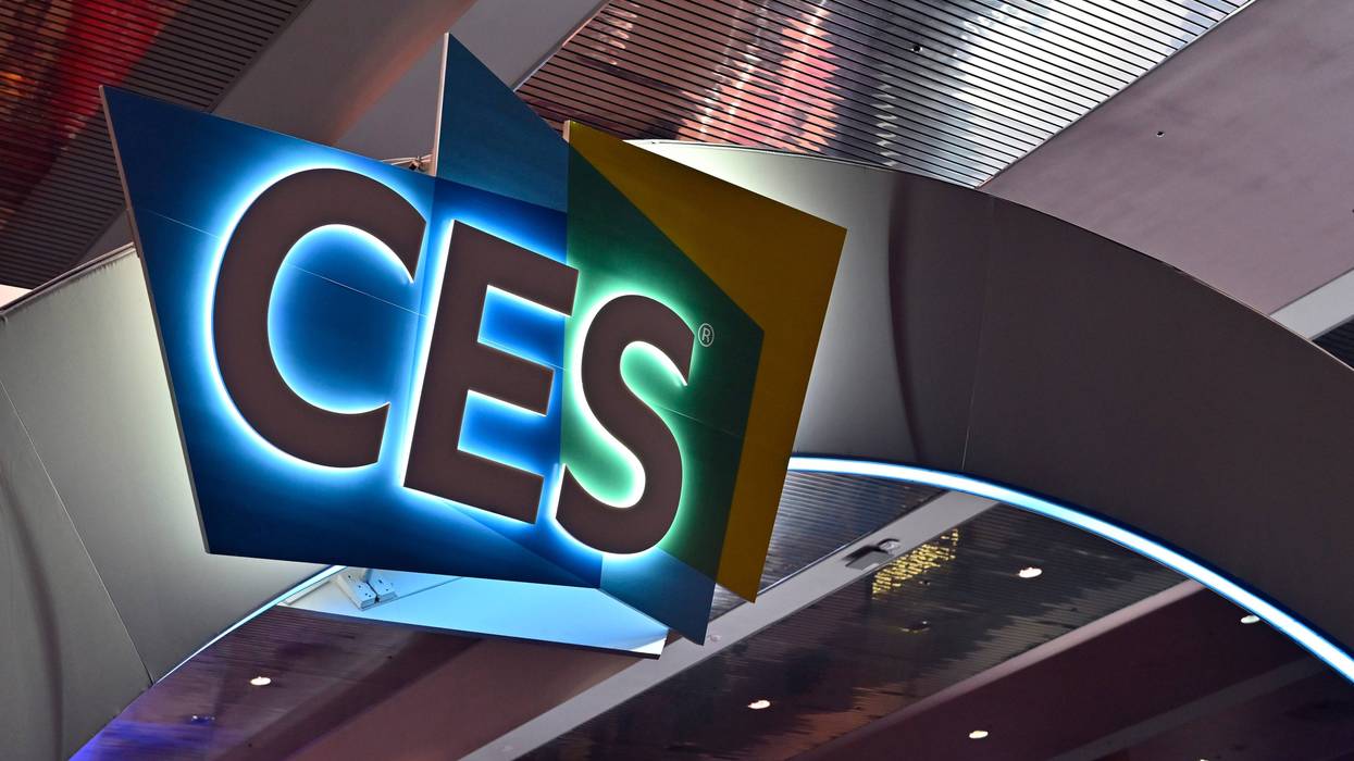 A lighted sign hangs over the floor of the Consumer Electronics Show
