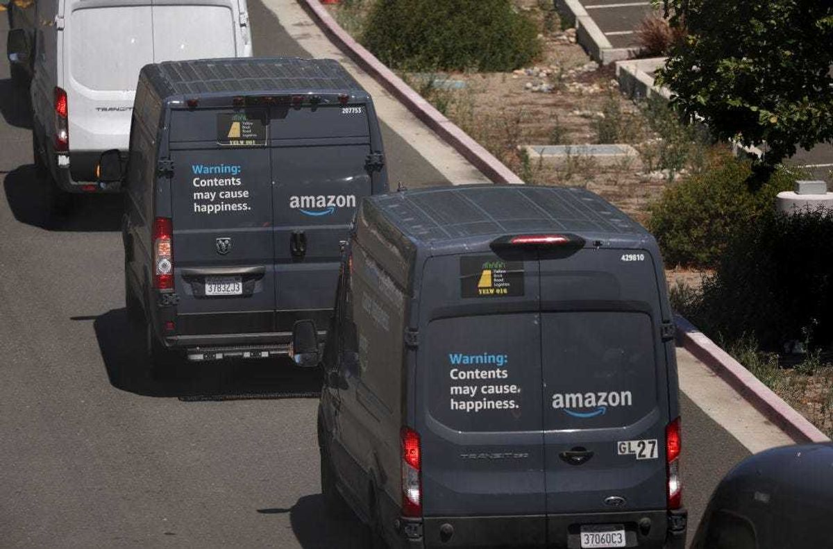 A line of Amazon delivery trucks leave an Amazon distribution facility on June 21, 2023 in Richmond, California. The Federal Trade Commission (FTC) sued Amazon alleging that company has deceived millions of customers into signing up for Prime subscription services and intentionally complicated the cancellation process. (Photo by Justin Sullivan/Getty Images)
