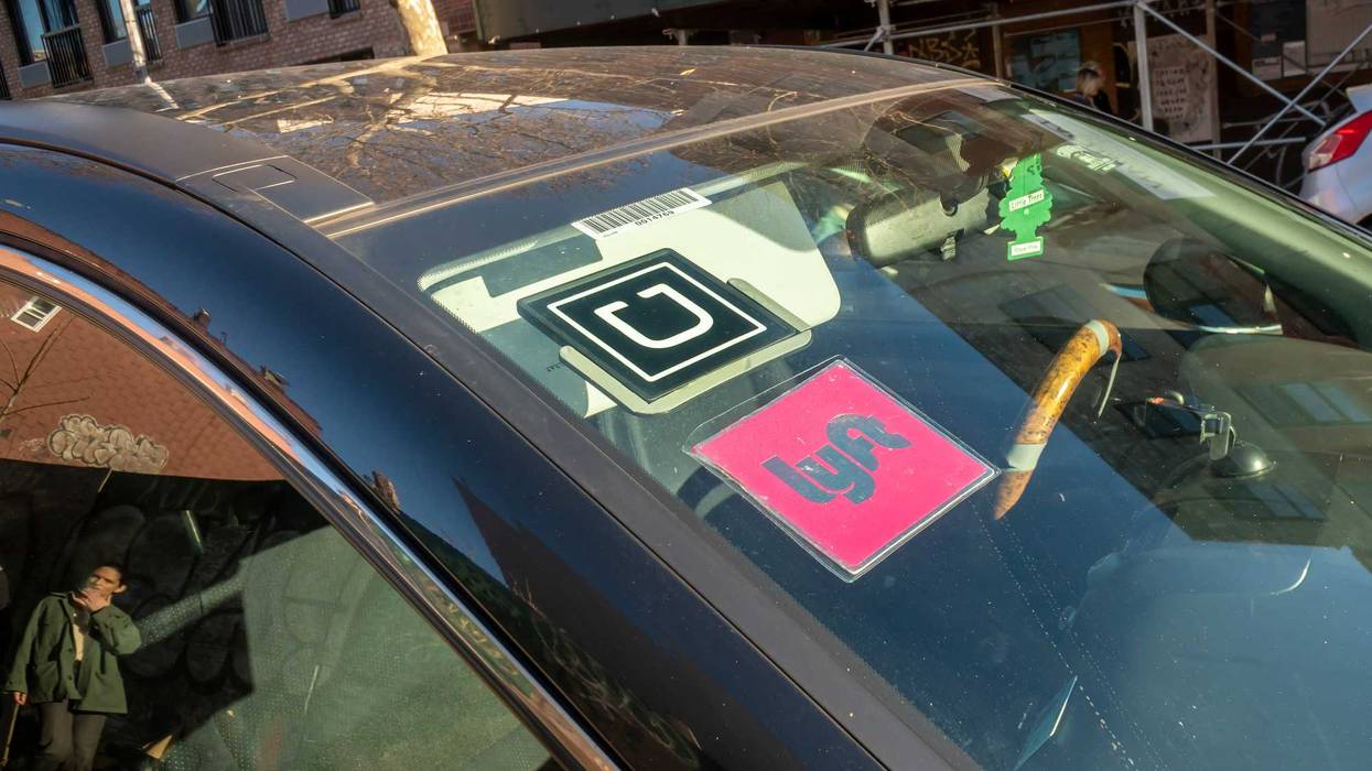 A livery with affiliation stickers for both competing Lyft and Uber in New York