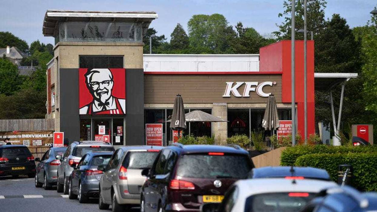 A long queue of cars forms as the KFC drive through re-opens to the public on May 08, 2020 in Plymouth, England.