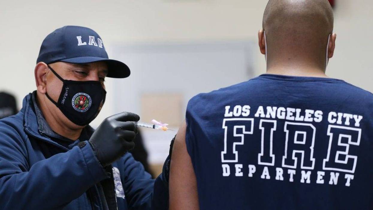 A Los Angeles Fire Department (LAFD) firefighter receives a Moderna COVID-19 vaccination.