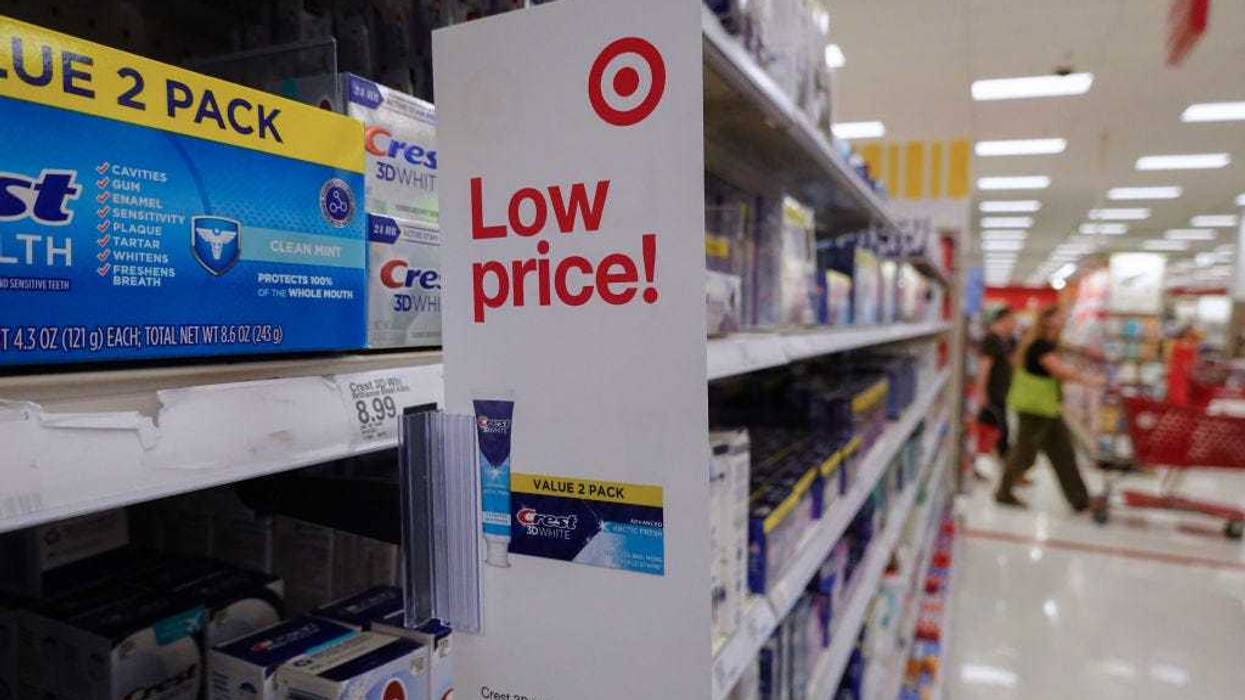 A low price sign hangs from a shelf at a Target store. Target announced plans to cut prices on thousands of consumer basics as inflation cuts into household budgets.