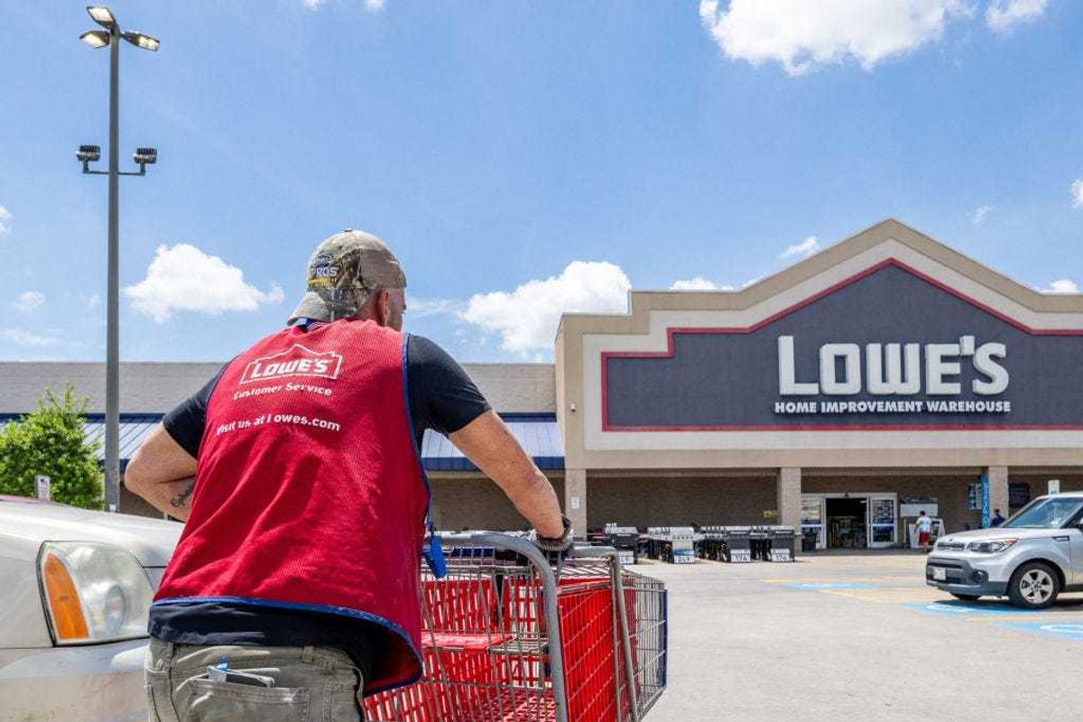 A Lowe's Home Improvement Warehouse worker collects carts in a parking lot on August 17, 2022 in Houston, Texas. Lowe's recently reported second-quarter earnings and improvements that show increased sales and the surpassing of analysts' expectations. (Photo by Brandon Bell/Getty Images)