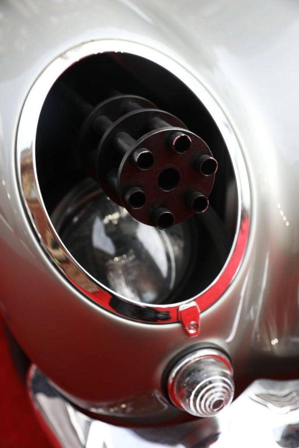 A machine gun poking of a headlight on James Bond