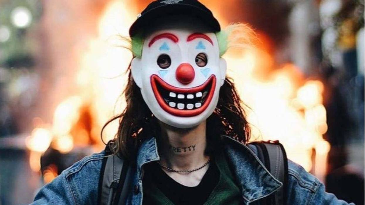 A man alleged to be Timothy O’Donnell poses in front of a burning Chicago police car in Chicago.