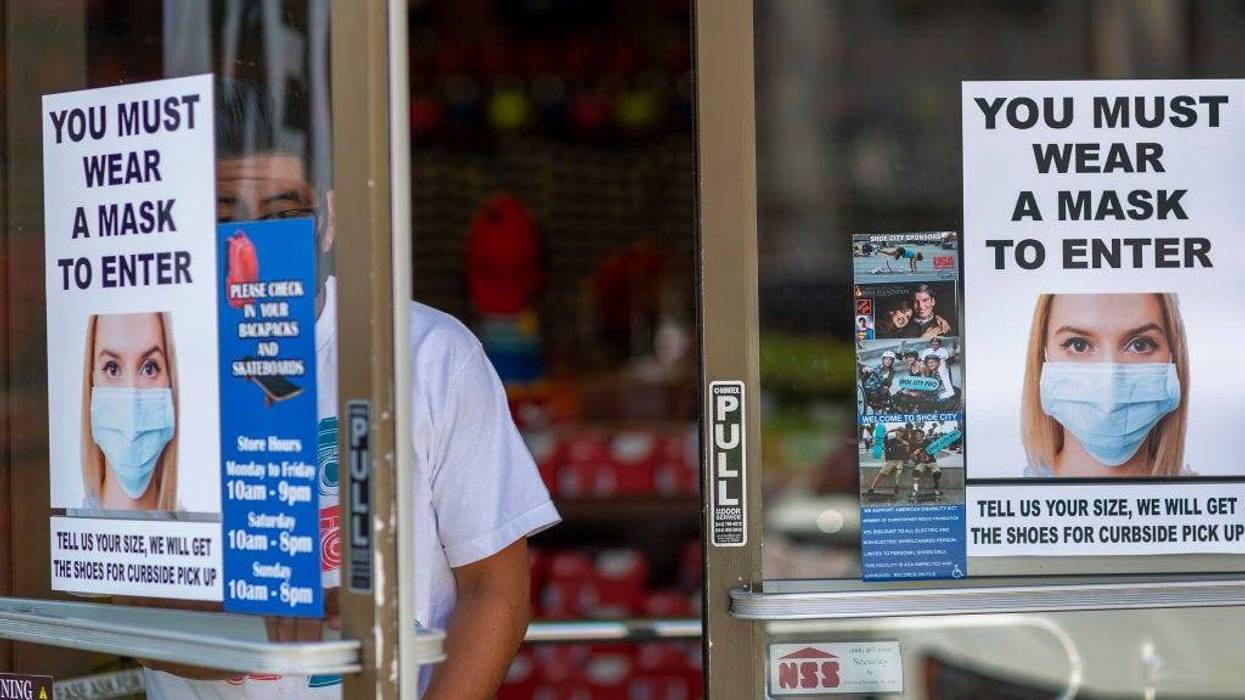 A man exits a Shoe City store where masks are required for entry as Los Angeles County retail businesses reopen while the COVID-19 pandemic continues on May 27, 2020 in Glendale, Californias latest guidelines and allow the resumption of in-store shopping at low-risk retail stores, faith-based services, drive-in theaters and other recreational activities with reduced capacities and social distancing restrictions, starting today.
