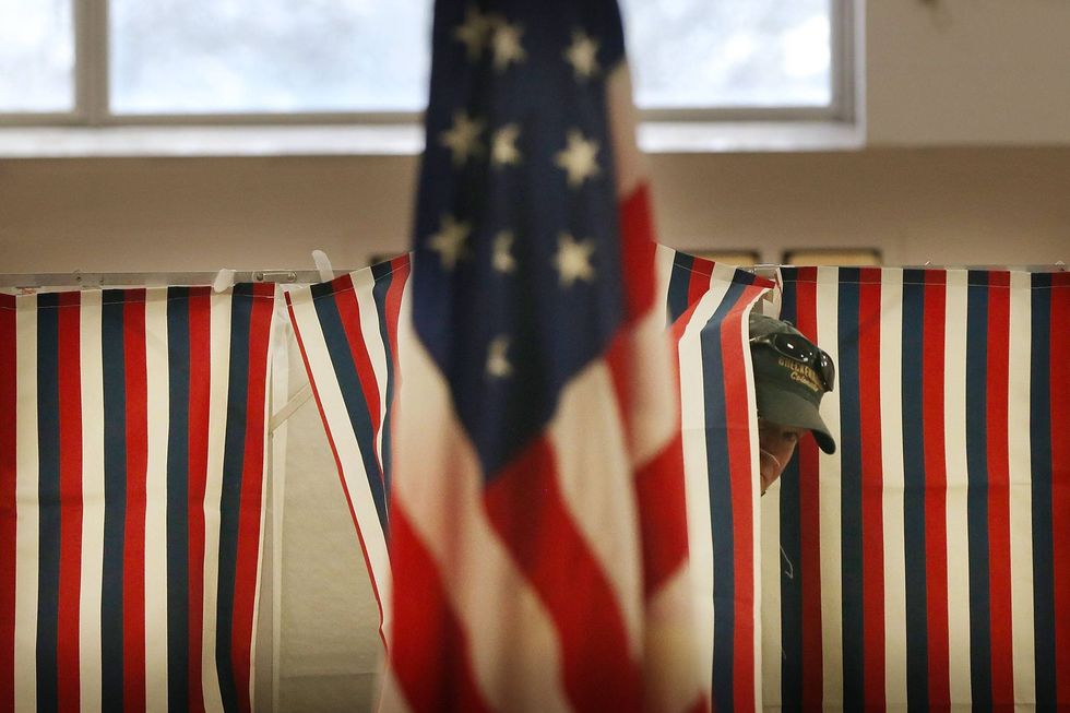 A man exits a voting booth inside of a middle school serving as a voting station on the day of the New Hampshire Primary on February 9, 2016 in Bow, New Hampshire.