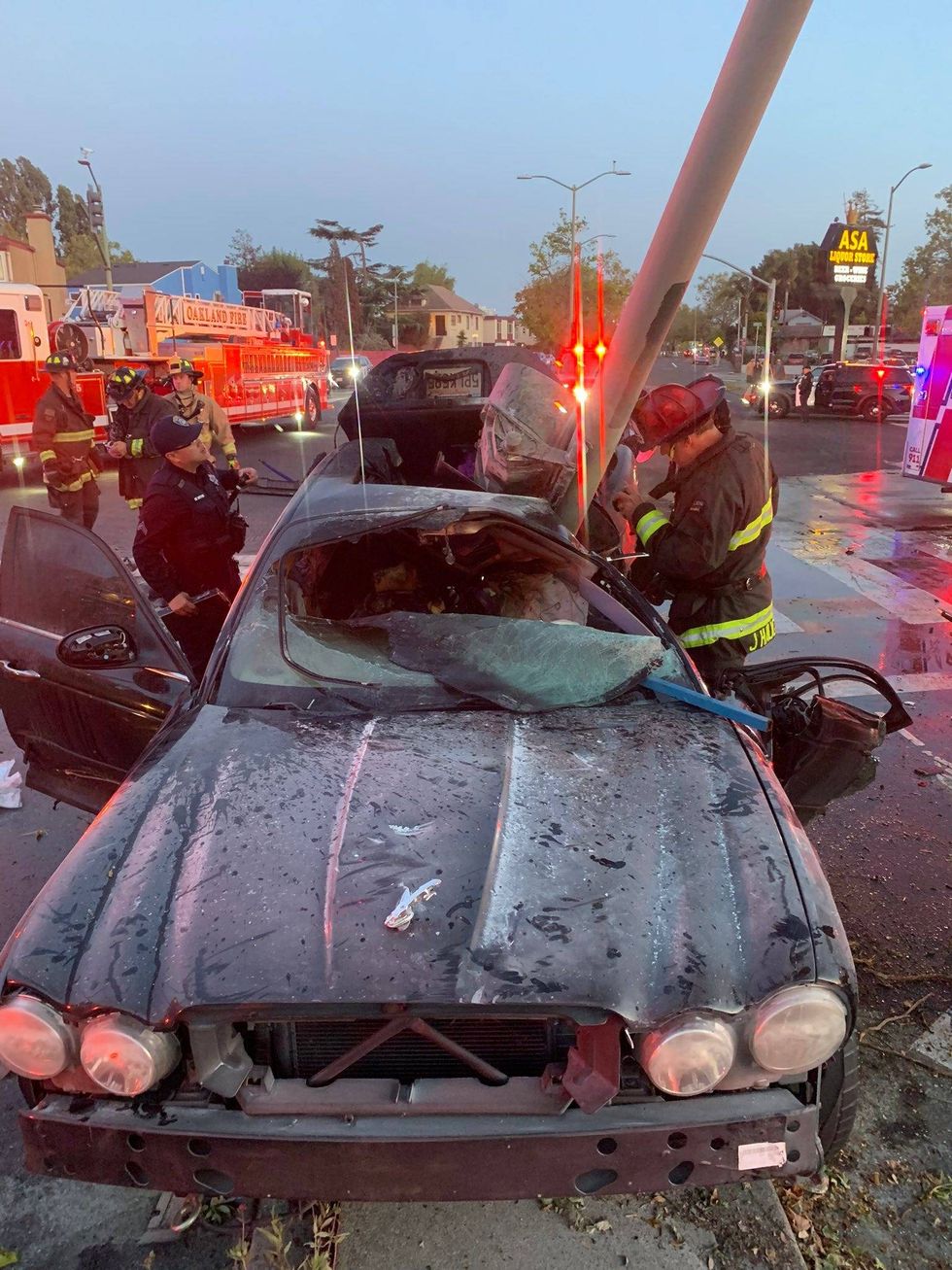 A man has survived a fiery car crash after Oakland residents used hoses and bottles of water to keep him alive until emergency crews arrived.