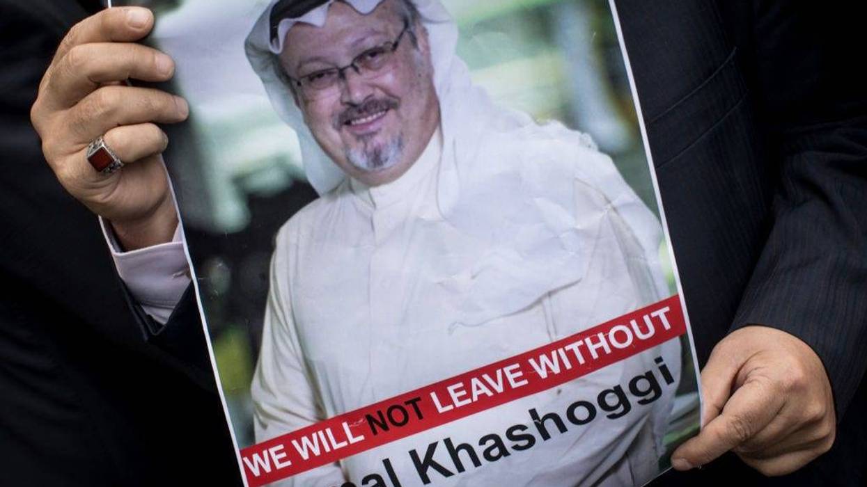 A man holds a poster of Saudi journalist Jamal Khashoggi during a protest organized by members of the Turkish-Arabic Media Association at the entrance to Saudi Arabia's consulate on October 8, 2018 in Istanbul, Turkey.