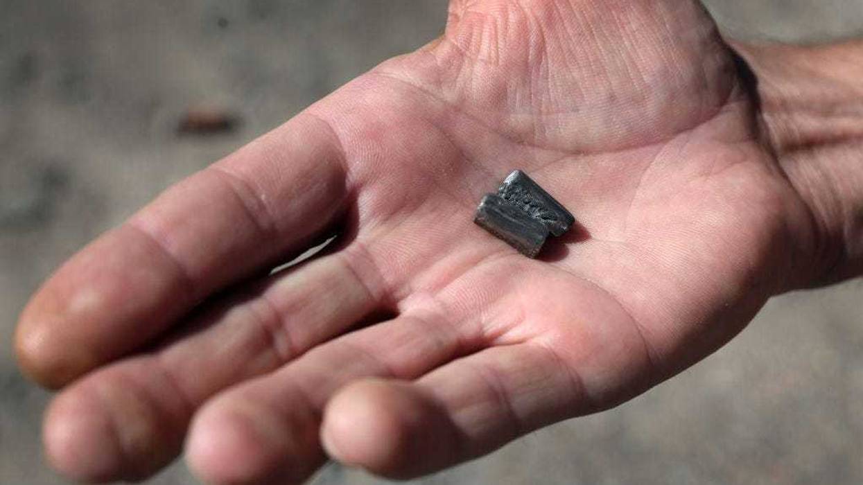 A man holds projectiles he recovered after a cluster bomb attack in his neighborhood on July 02, 2022 in Sloviansk, Ukraine. Four people were killed and 7 others were injured in the attack which occurred yesterday afternoon. Russia has been slowly making gains in the parts of Donetsk Oblast not already under its control and recently has been stepping up attacks on Sloviansk and nearby Bakhmut. (Photo by Scott Olson/Getty Images)