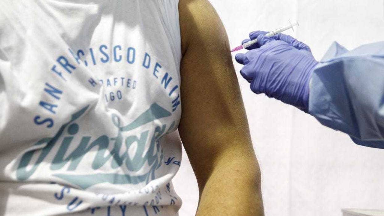 A man is given a dose of the Moderna vaccine in a temporary vaccination center in Berlin, Germany.