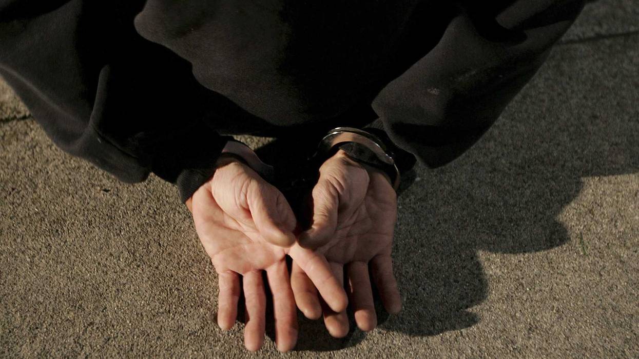 A man is handcuffed after he was arrested by San Bruno police officers for driving under the influence of narcotics at a DUI checkpoint on November 27, 2006 in San Bruno, California.
