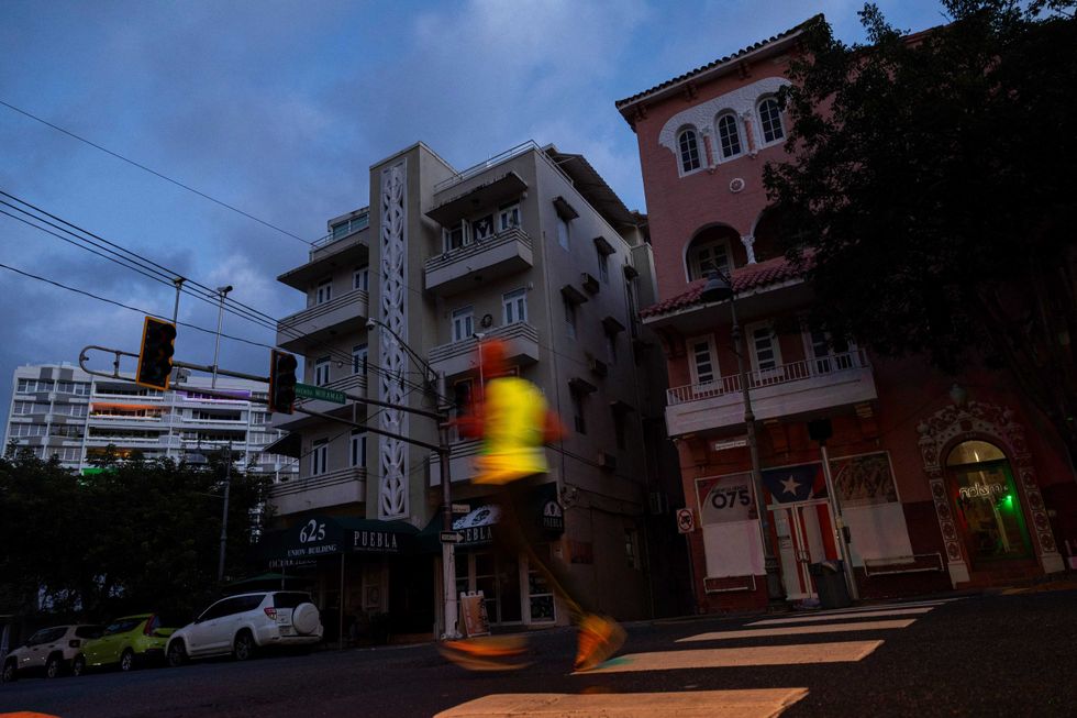 A man jogs on a dark street in San Juan, Puerto Rico after a major power outage hit the island on December 31, 2024