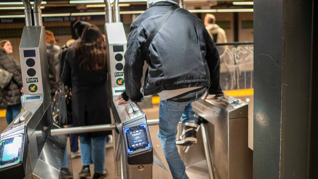 A man jumps a turnstile in the subway earlier this year