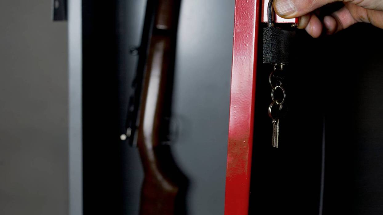 A man locking up his gun.
