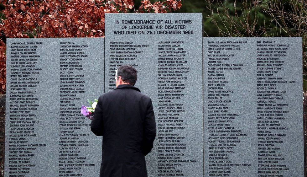 A man looks at the main memorial stone in memory of the victims of the bombing of Pan Am flight 103, in the garden of remembrance near Lockerbie, Scotland on Dec. 21, 2018.