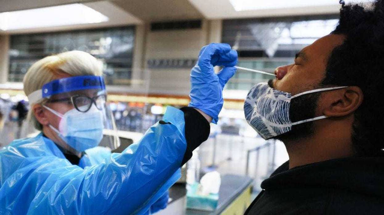 A man receives a nasal swab COVID-19 test at Tom Bradley International Terminal at Los Angeles International Airport (LAX) amid a coronavirus surge in Southern California on December 22, 2020 in Los Angeles, California.
