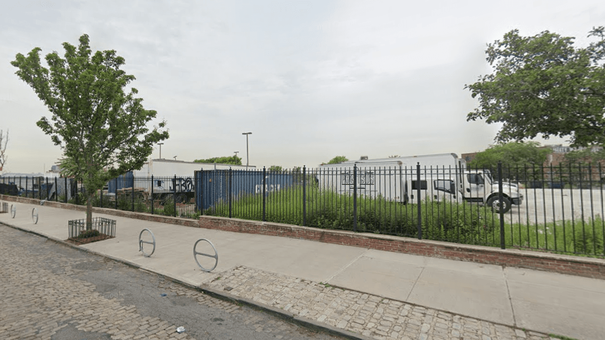 A man's body was found early Saturday morning after a boat fire was extinguished in a fenced-in parking lot in Red Hood, Brooklyn.