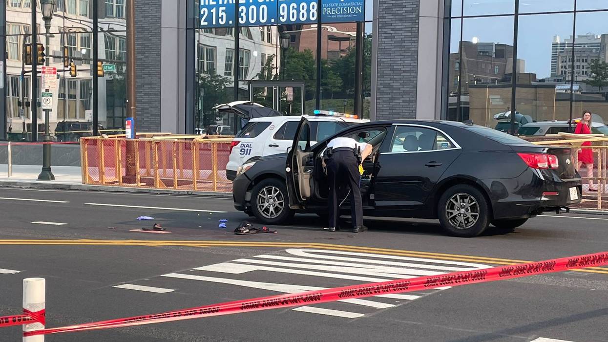 A man's shoes are still on Market Street near his car, where police found him, after he had been shot in an apparent road rage incident by a woman he threatened with a crowbar.