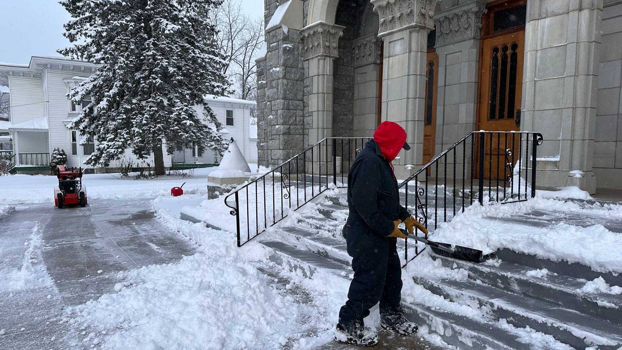 A man shovels snow outside a church in Lowville, N.Y., on Friday, Nov. 28, 2025