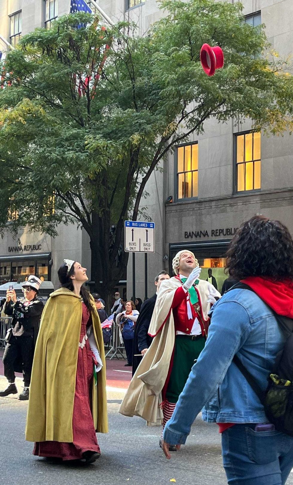 A man tosses his hat into the air at the parade