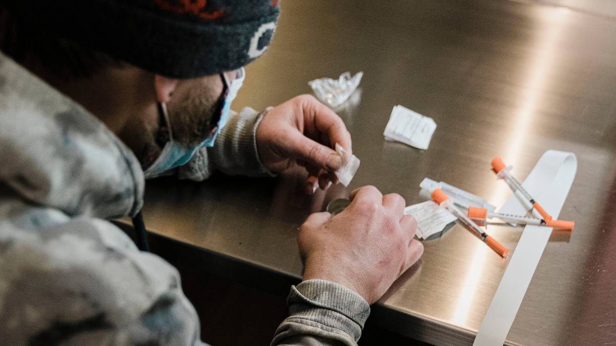 A man utilizes a narcotic consumption booth at a safe injection site in New York City.