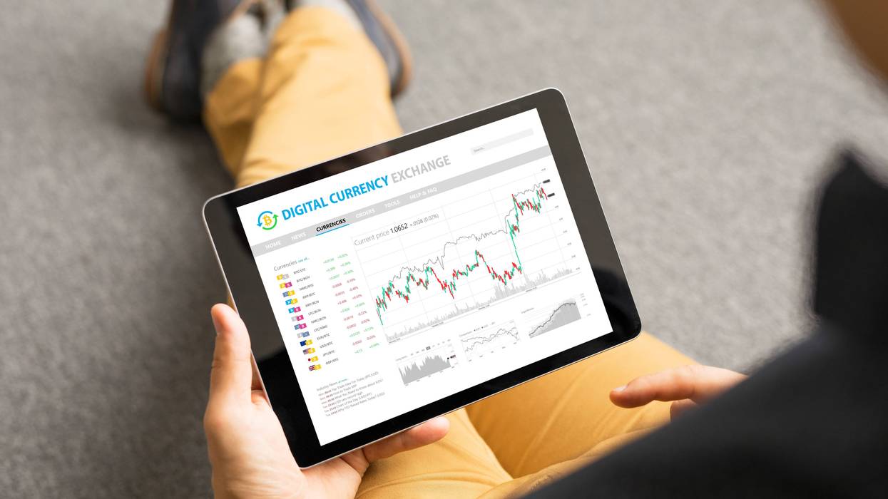 A man views a cryptocurrency exchange on his tablet.