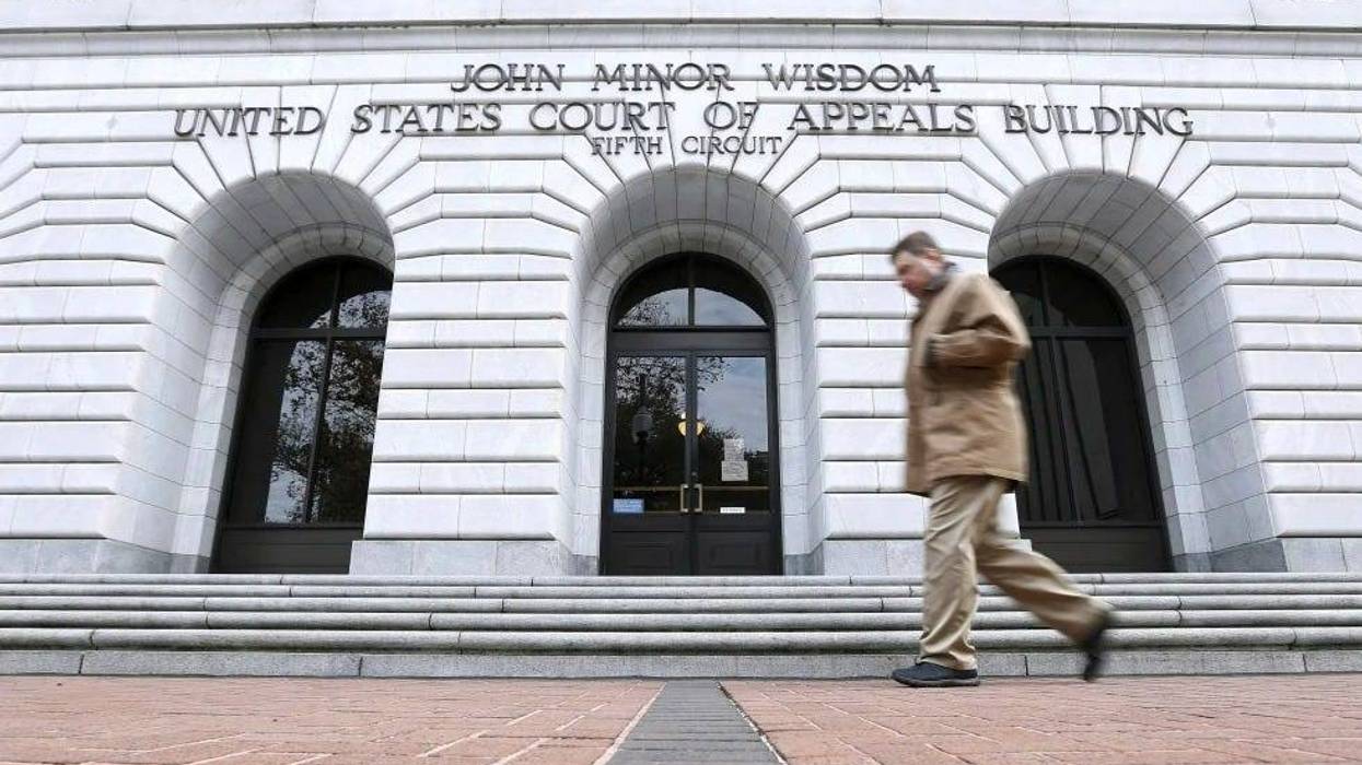 A man walks in front of the 5th U.S. Circuit Court of Appeals, Jan. 7, 2015, in New Orleans.