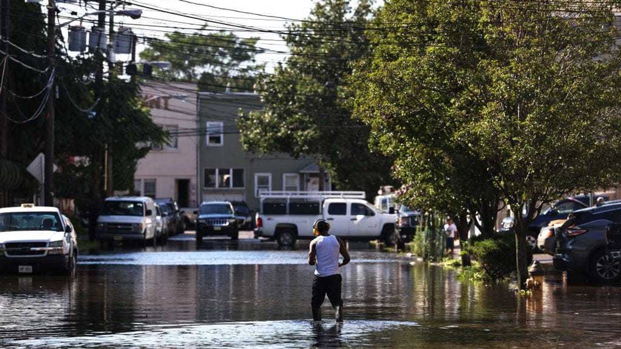 A man walks through a flooded Clifford Street on September 02, 2021 in Newark, New Jersey.