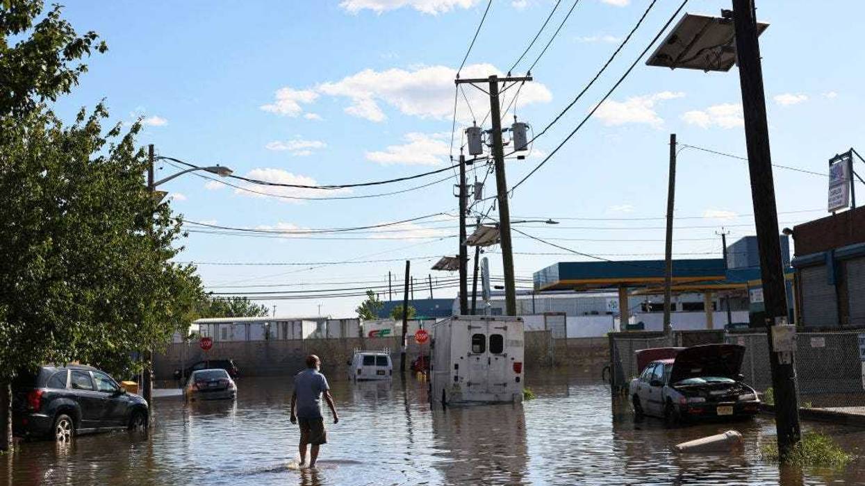 A man walks through a flooded Van Buren Street on September 02, 2021 in Newark, New Jersey.